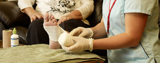 Nurse wrapping foot